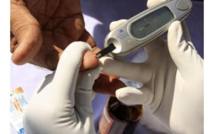 RBC health worker advising a patient about diabetes prevention and testing in Rwanda.
