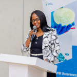 Healthcare workers analyzing laboratory samples related to antimicrobial resistance in Rwanda.