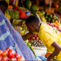 Traders and customers at a local market in Rwanda as prices rise amid inflation in 2025.