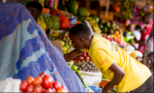 Traders and customers at a local market in Rwanda as prices rise amid inflation in 2025.