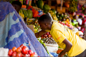Traders and customers at a local market in Rwanda as prices rise amid inflation in 2025.