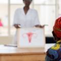 A Rwandan woman using a home-based cervical cancer self-screening kit provided by Rwanda Biomedical Centre.
