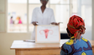 A Rwandan woman using a home-based cervical cancer self-screening kit provided by Rwanda Biomedical Centre.