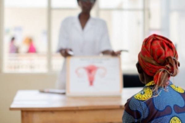 A Rwandan woman using a home-based cervical cancer self-screening kit provided by Rwanda Biomedical Centre.