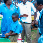 Ministry of Health officials and students during the Fresheri ku Ishuri hygiene campaign at G.S. Cyarwa in Huye District
