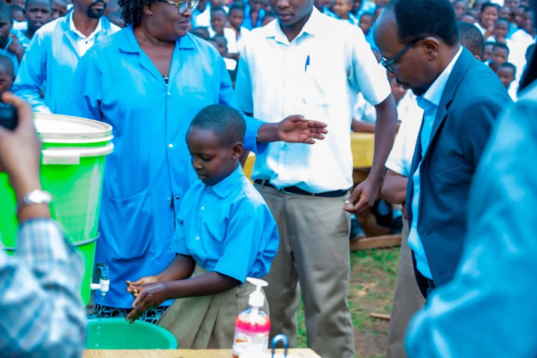 Ministry of Health officials and students during the Fresheri ku Ishuri hygiene campaign at G.S. Cyarwa in Huye District
