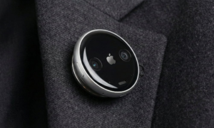 AI Pin wearable device attached to clothing, designed as a screenless alternative to smartphones